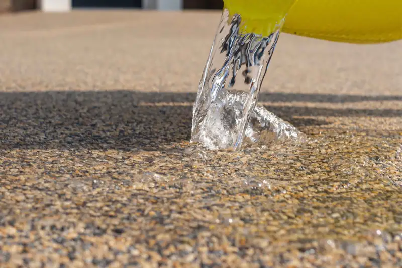 Water poured onto a resin-bound surface soaking straight in